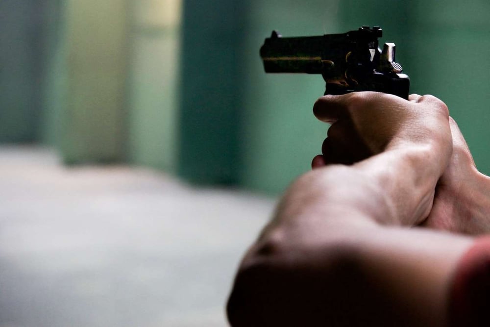 man pointing a revolver