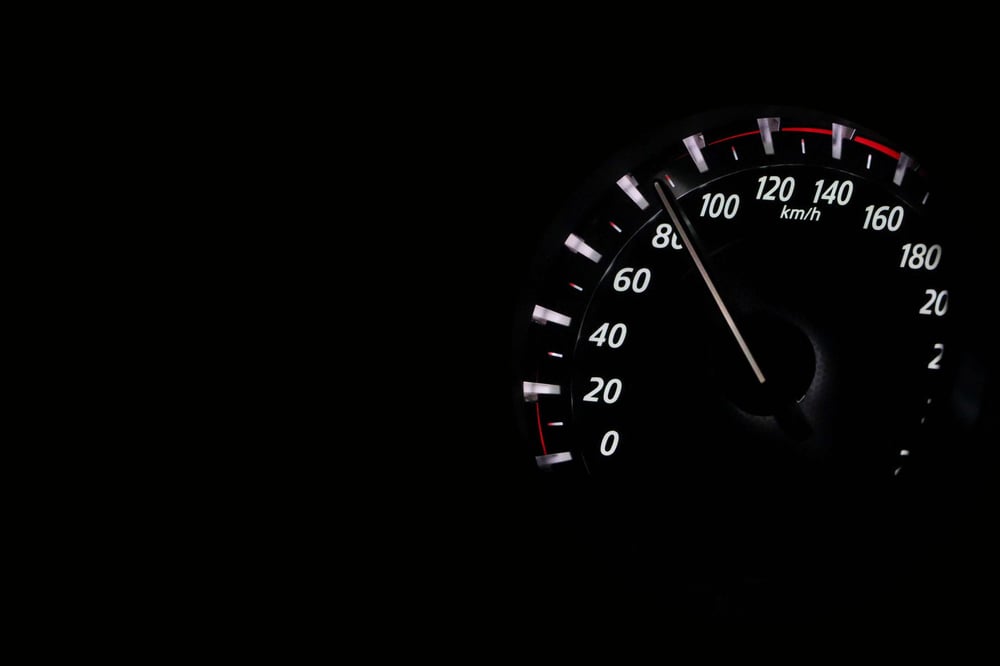 Speedometer showing over 80 mph at night