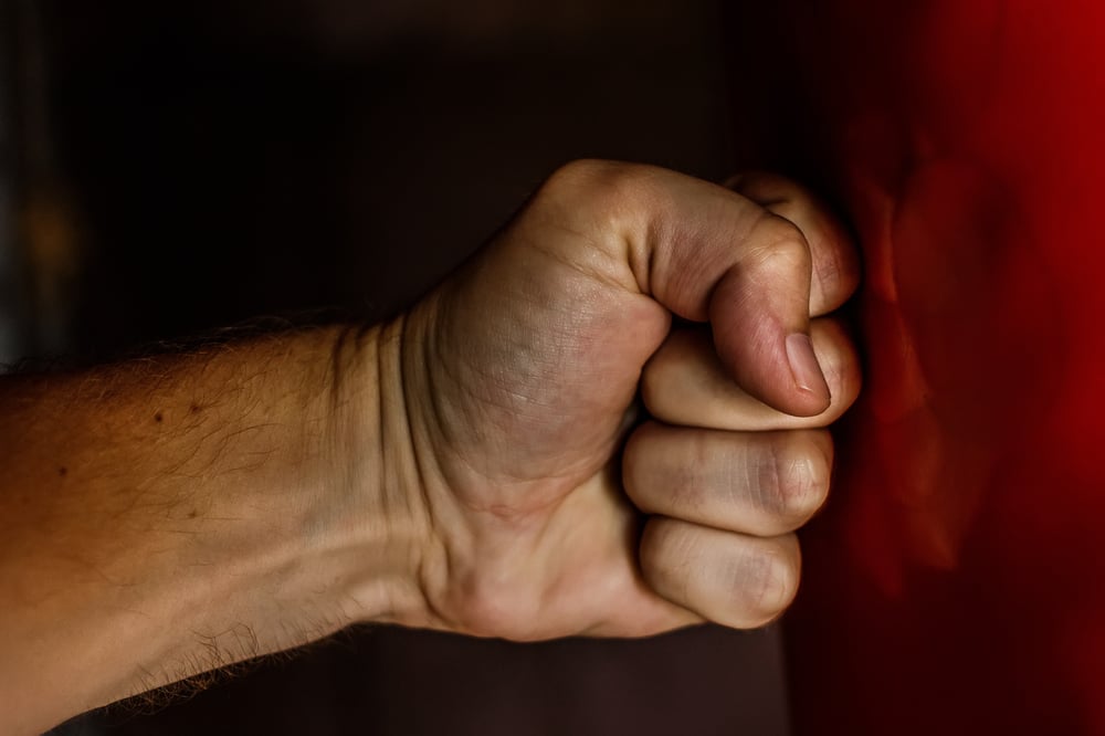 fist punching red cushion