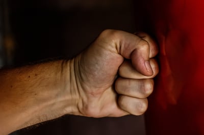 fist punching red cushion
