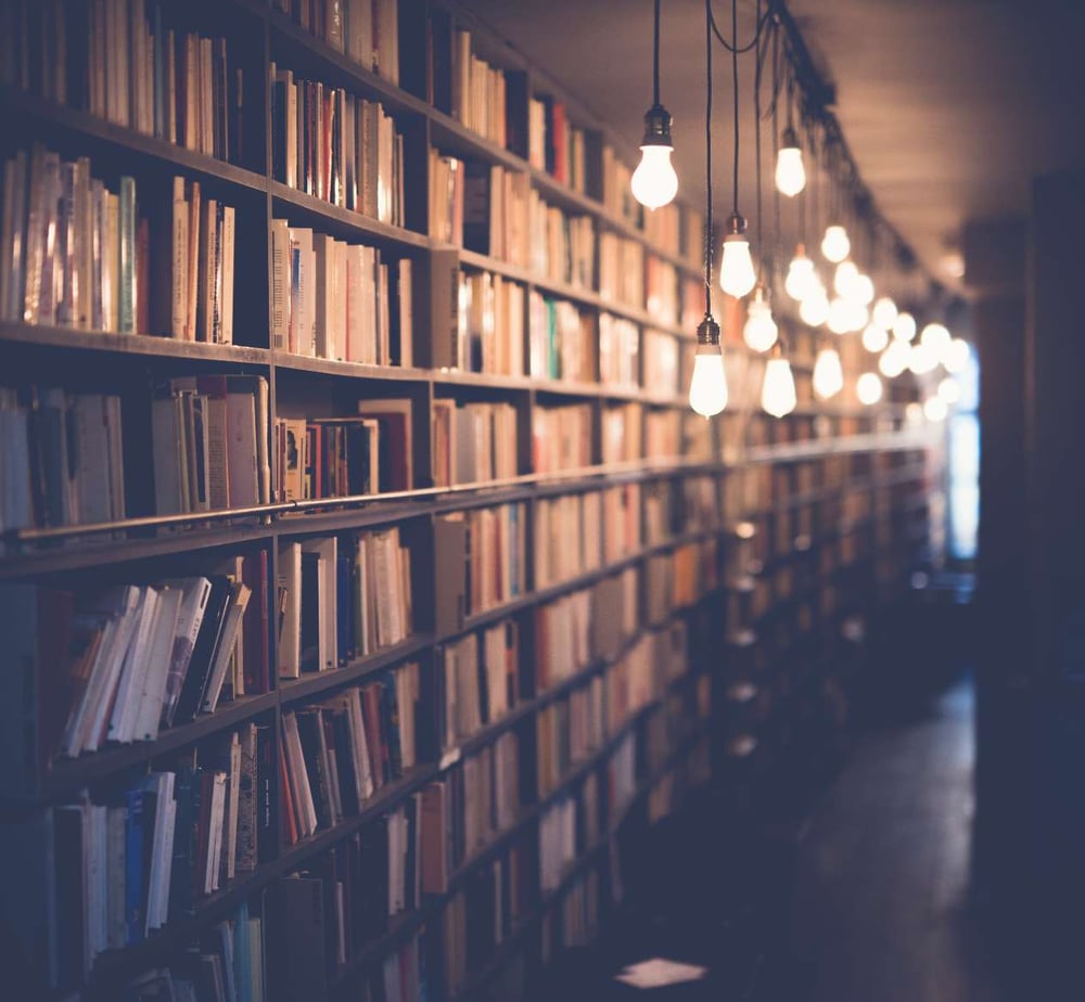 dim library lit by dangling lights