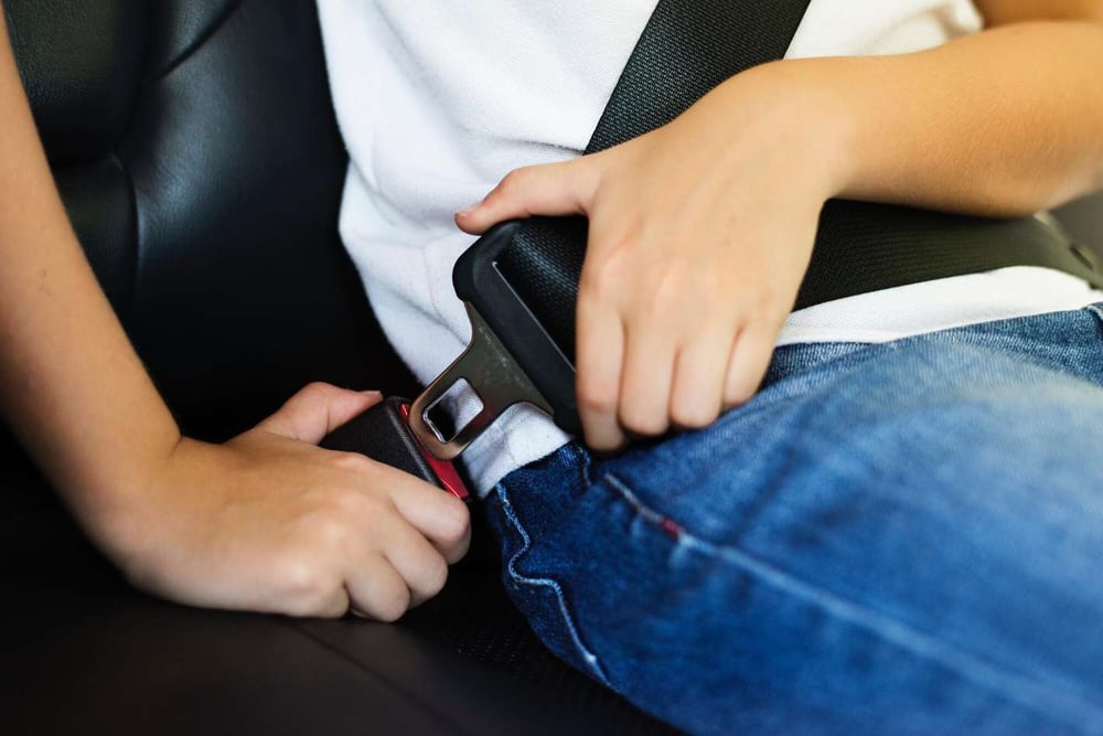 minor passenger buckling their seatbelt