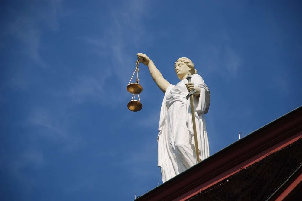 statue of a woman holding a scale