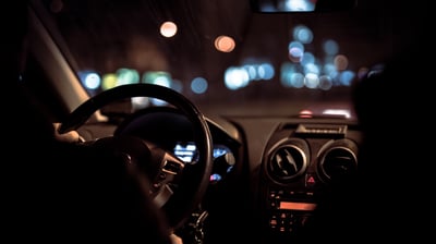 person driving through the city at night